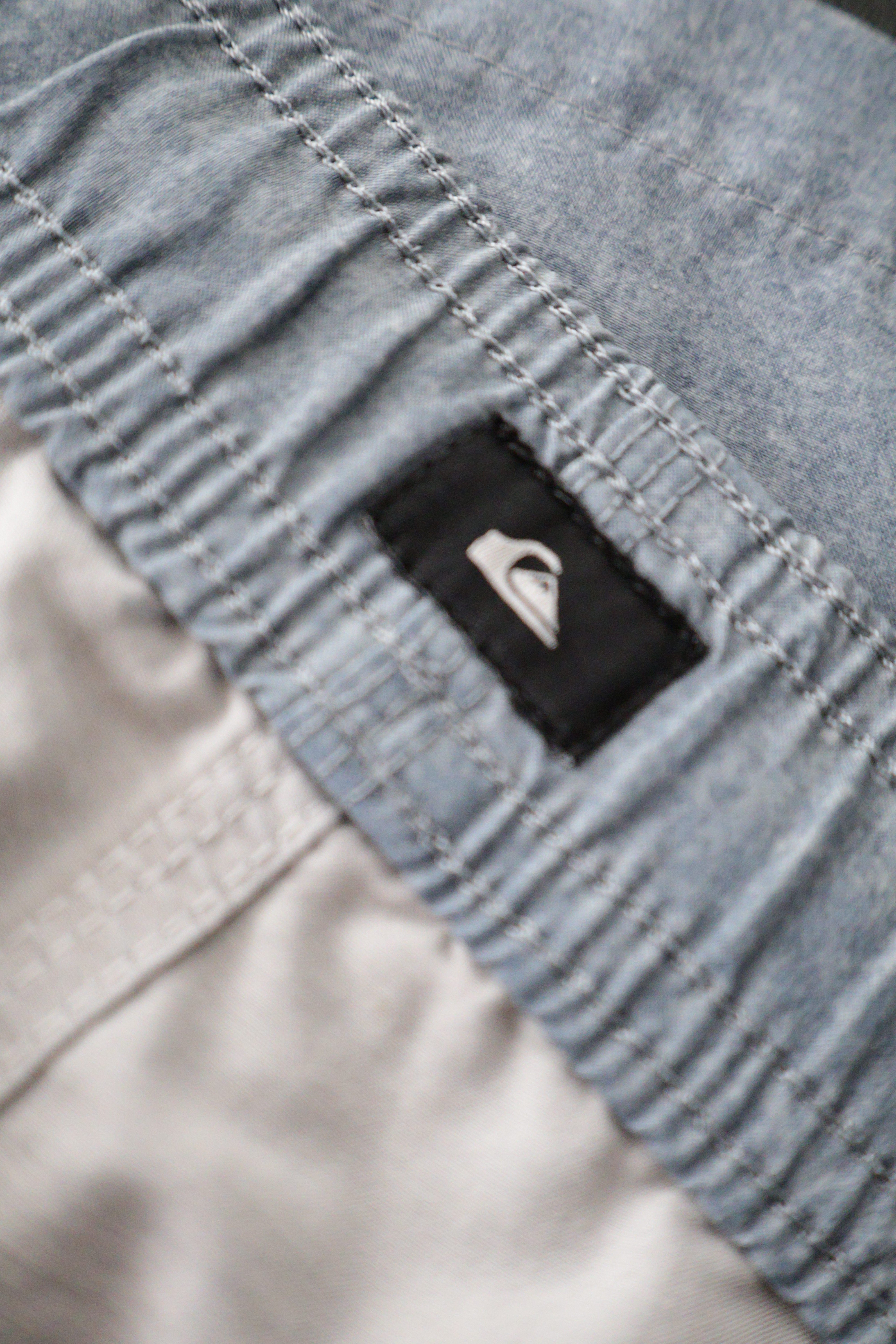 Eticheta marime si compozitie (rotita dreapta) - Pantaloni scurți - Quiksilver bleu deschis din material usor cu snur in talie – L – Bărbați