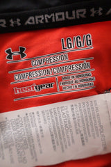 Maiou Under Armour portocaliu cu negru mărime L etichetă mărime și compoziție second-hand premium